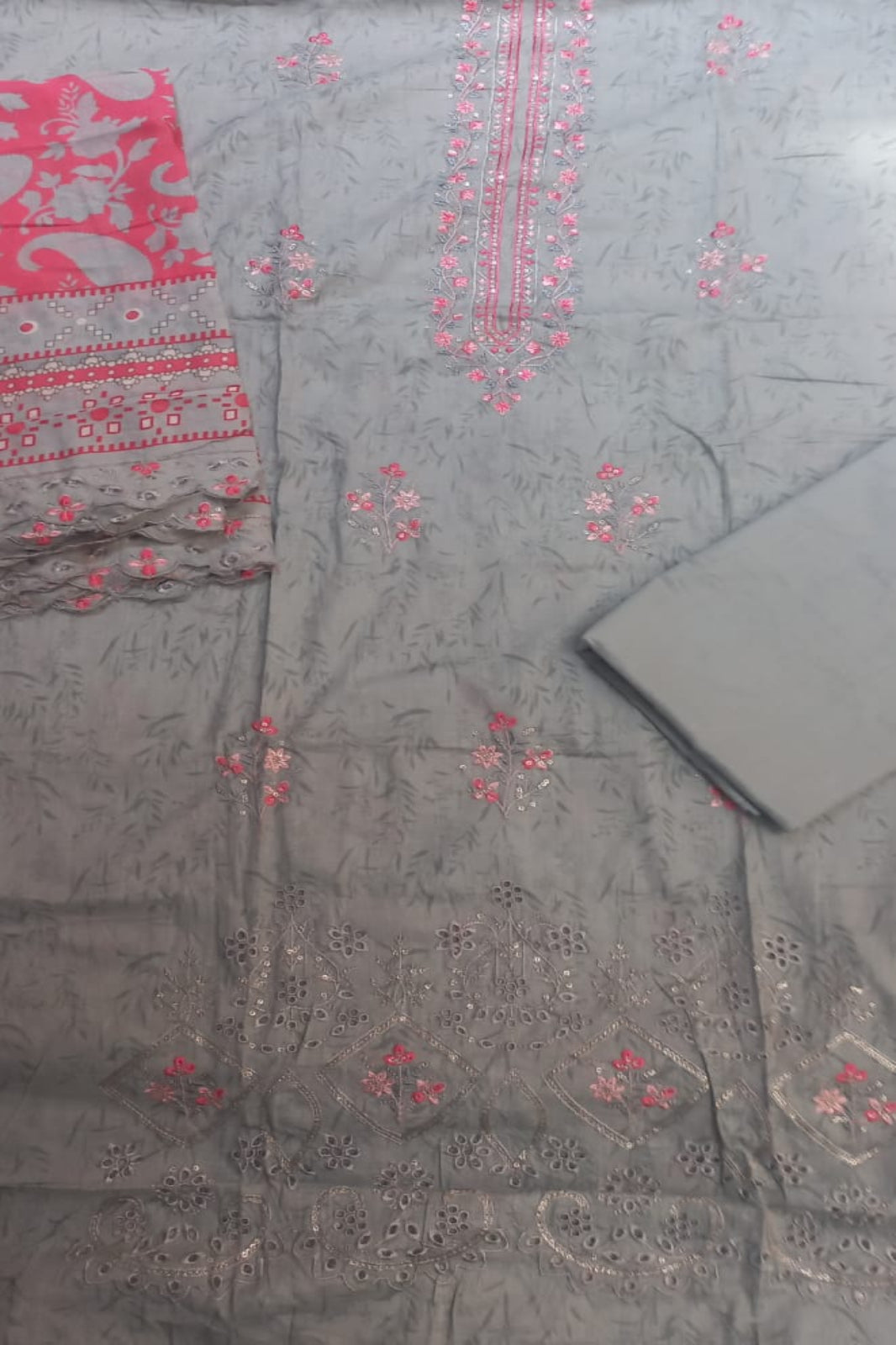 AlZohaib unstitched textile with red floral patterns on a grey background