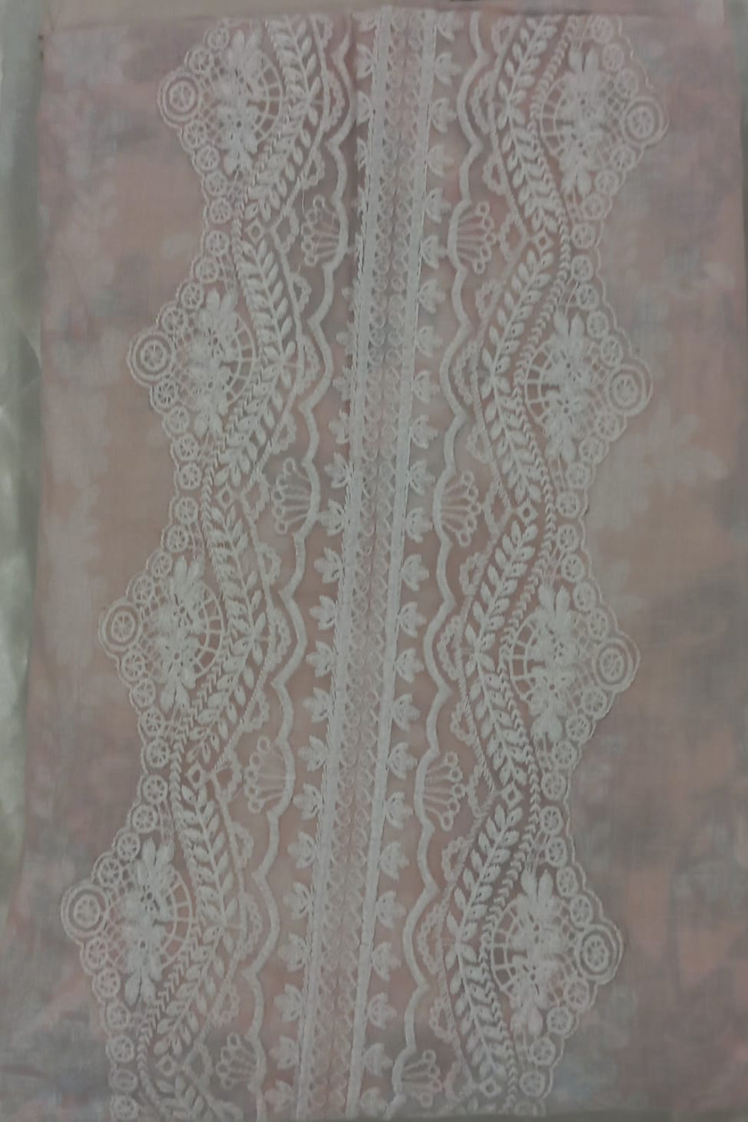 Cosmos Wonder decorative lace pattern on a textured fabric background