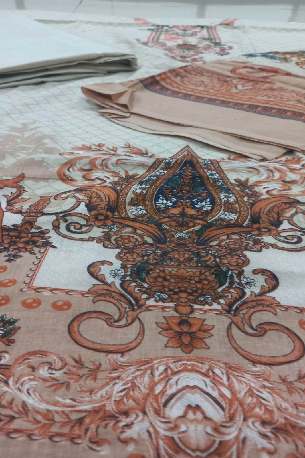 Decorative fabric with intricate patterns and designs on a white background