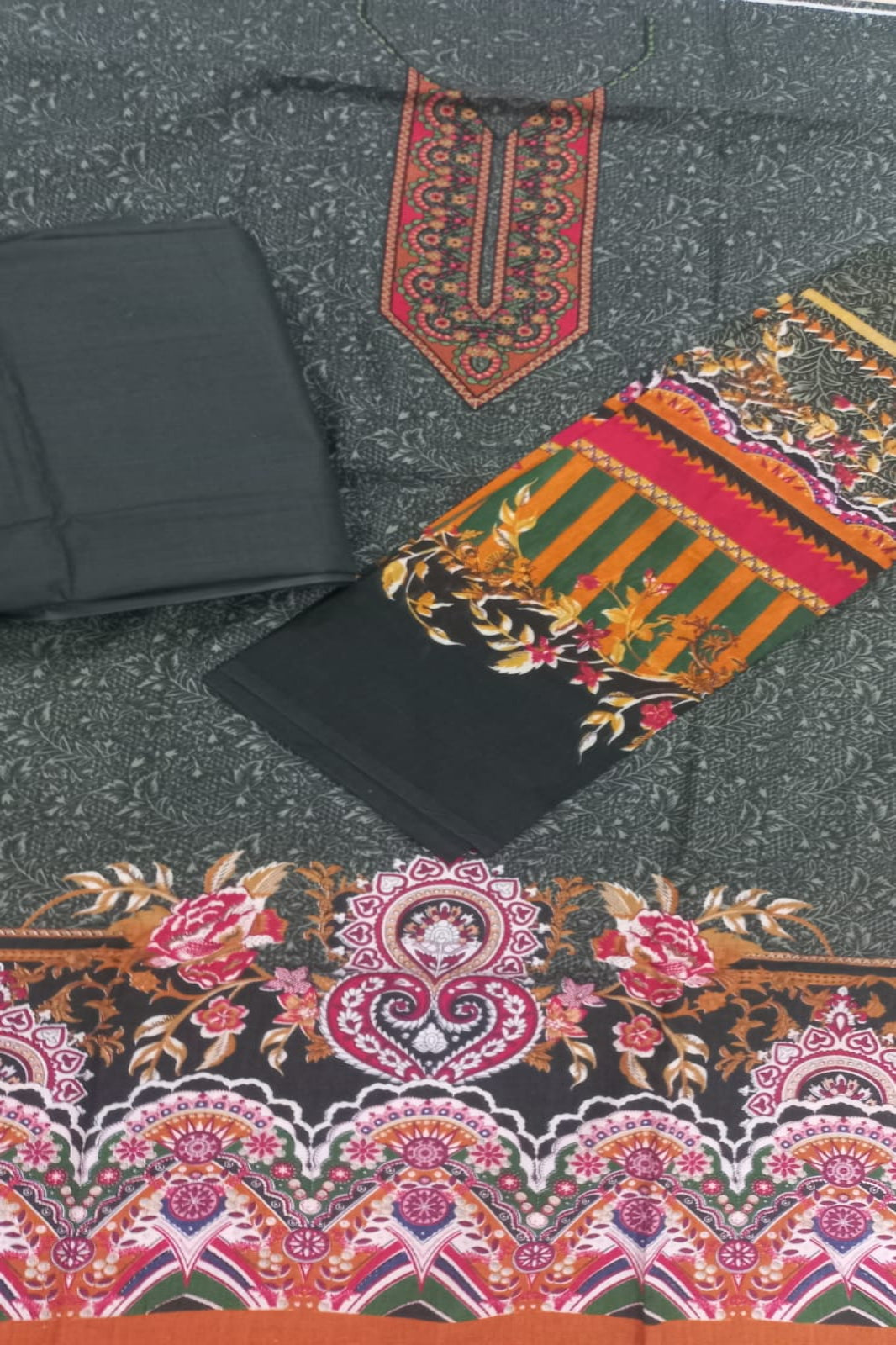 Decorative fabric with intricate patterns on a textured surface