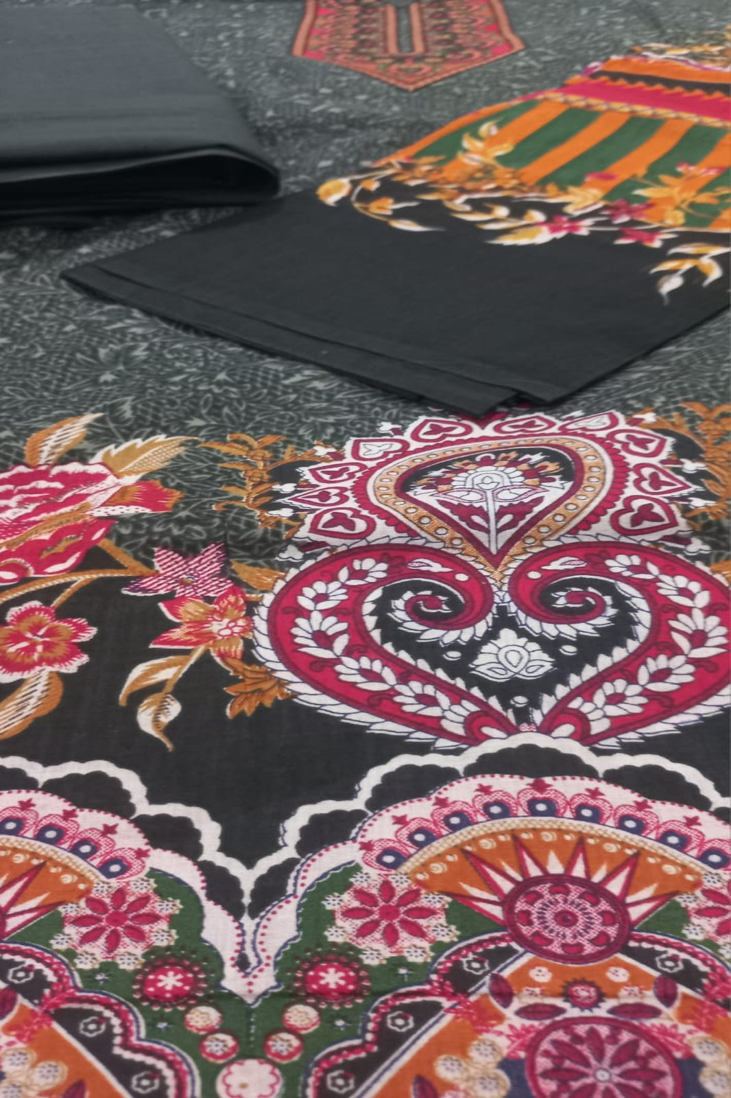 Embroidered fabric with intricate patterns on a black background