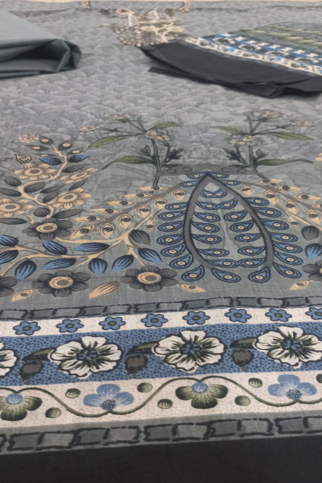 Close-up of a floral patterned fabric with blue and white design on a dark background