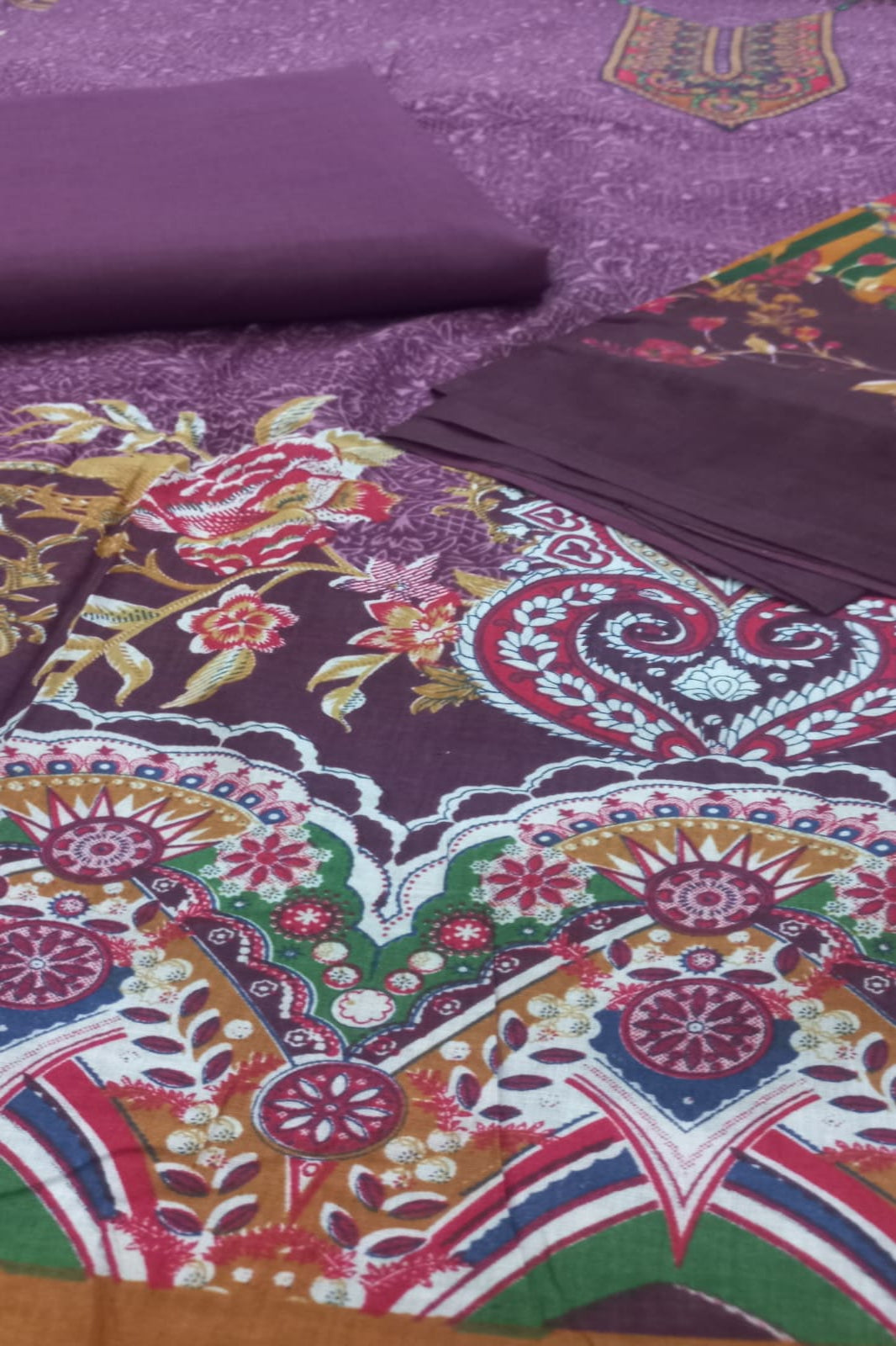 Colorful fabric with intricate patterns on a purple background