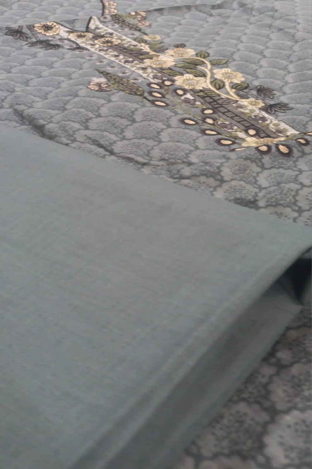 Close-up of a textured fabric with intricate patterns on a light blue background